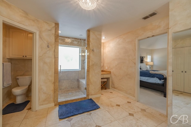 82 Bay Shore Ct, Abilene, TX 79602 - ensuite bathroom featuring tiled shower, tile patterned flooring, and toilet
