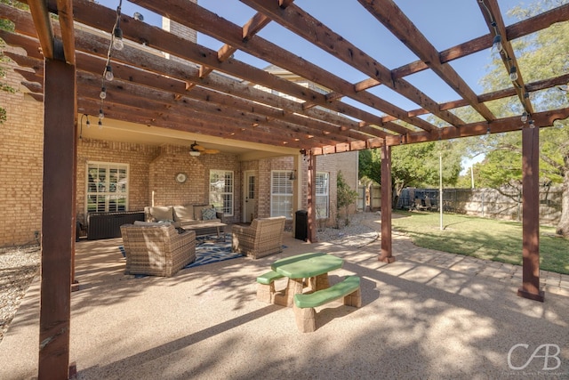 view of patio with an outdoor living space, ceiling fan, and a pergola