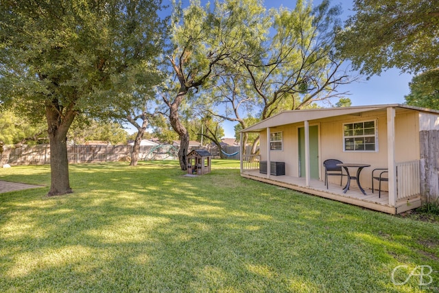 82 Bay Shore Ct, Abilene, TX 79602 - view of yard with central AC unit, a wooden deck, and an outdoor structure