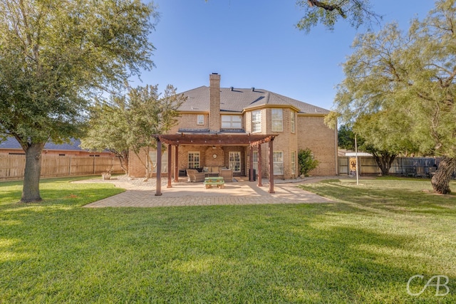 rear view of house featuring a lawn and a patio area