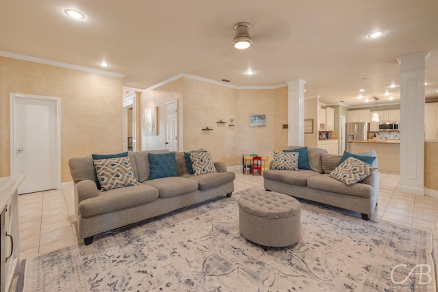 tiled living room with decorative columns, ceiling fan, and ornamental molding