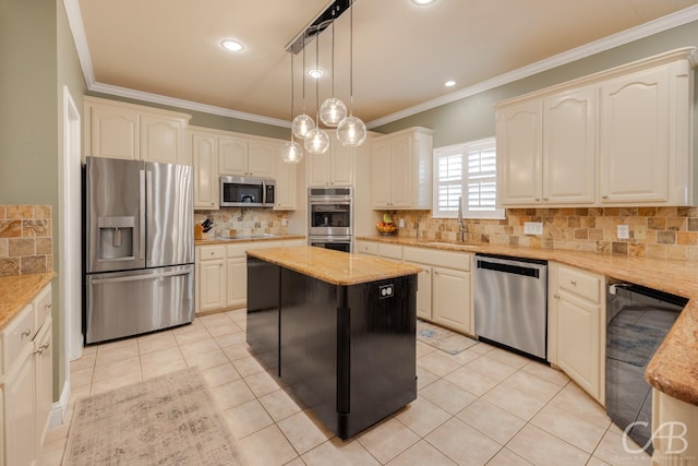 kitchen featuring pendant lighting, light stone counters, crown molding, and appliances with stainless steel finishes