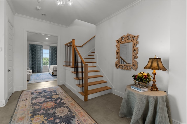 stairway featuring hardwood / wood-style floors and crown molding