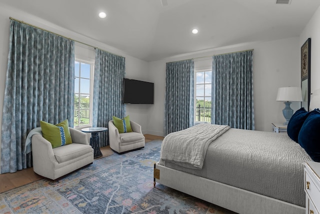 bedroom featuring multiple windows and hardwood / wood-style flooring