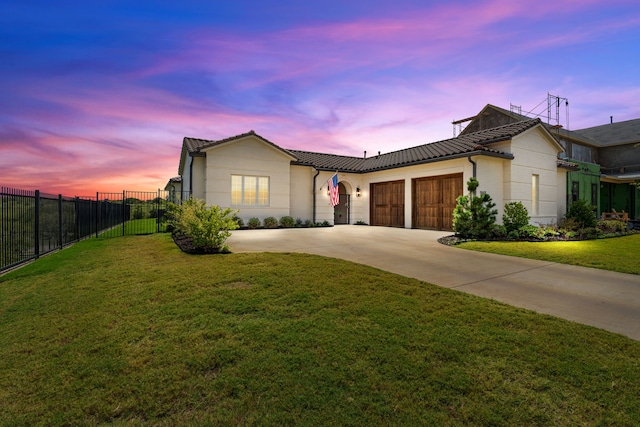 single story home with a garage and a yard