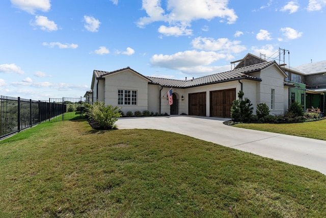 view of front of property featuring a garage and a front lawn