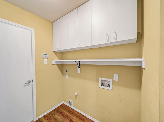 washroom featuring gas dryer hookup, electric dryer hookup, hookup for a washing machine, dark hardwood / wood-style floors, and cabinets