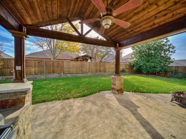 view of patio with ceiling fan and an outdoor fire pit