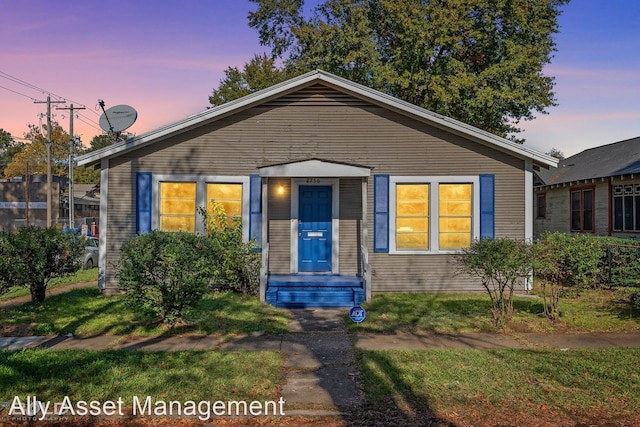 bungalow-style home featuring a yard