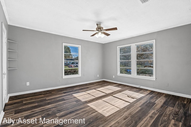 spare room with plenty of natural light, dark hardwood / wood-style floors, crown molding, and ceiling fan