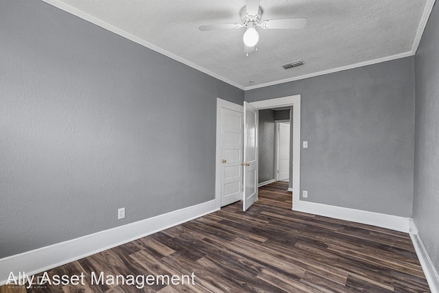 spare room with a textured ceiling, dark hardwood / wood-style floors, ceiling fan, and crown molding