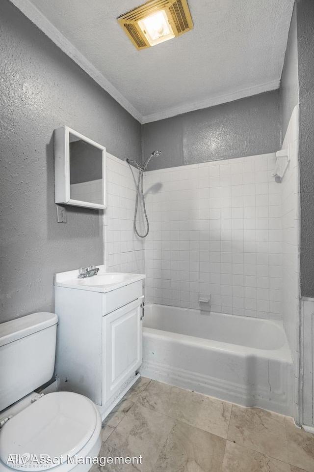 full bathroom with toilet, vanity, a textured ceiling, and tiled shower / bath combo