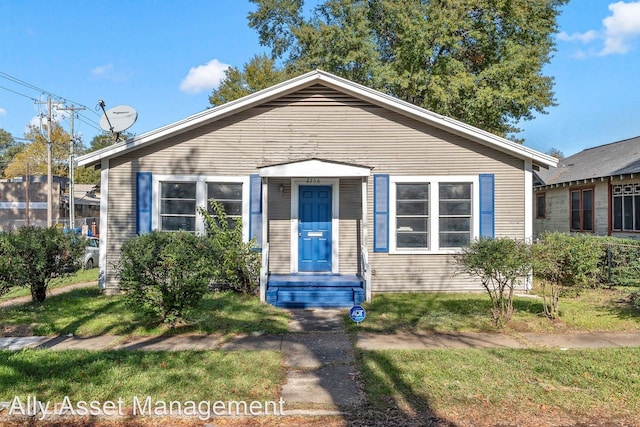 bungalow-style house featuring a front yard