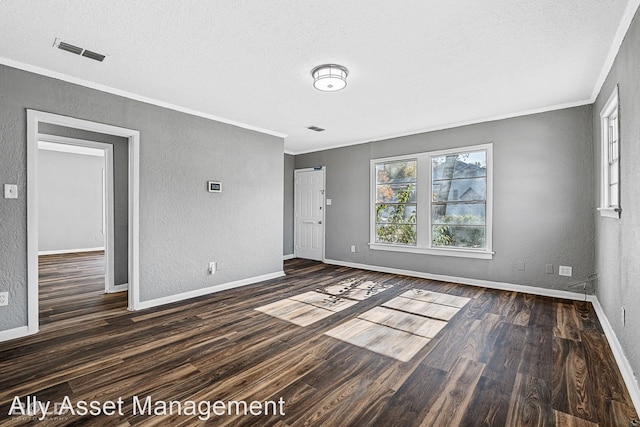 unfurnished room with dark wood-type flooring, crown molding, and a textured ceiling