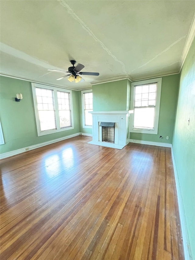 unfurnished living room with hardwood / wood-style floors, ceiling fan, and ornamental molding