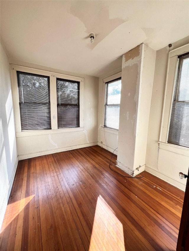 unfurnished room with hardwood / wood-style flooring