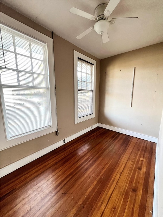 spare room featuring hardwood / wood-style floors and ceiling fan