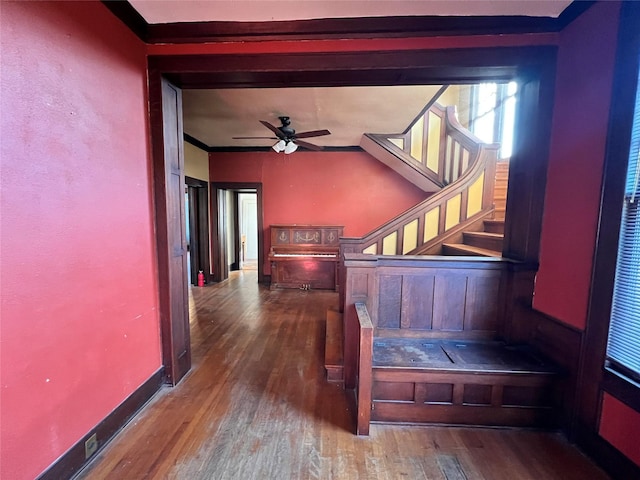 interior space with hardwood / wood-style flooring, ceiling fan, and ornamental molding