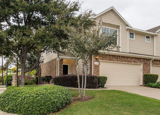 view of front of property featuring a garage and a front yard