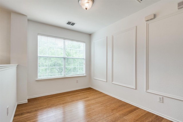 empty room with light hardwood / wood-style flooring