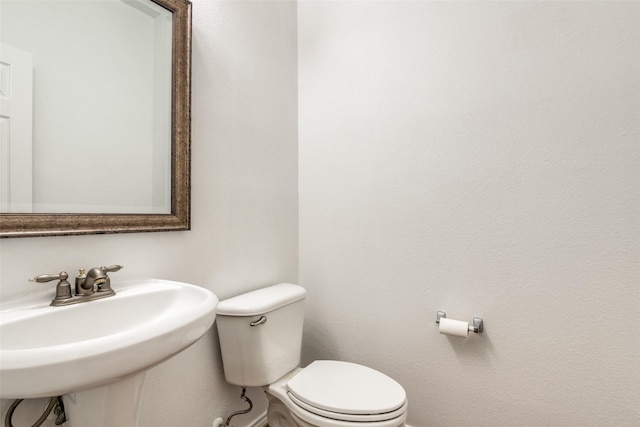 bathroom with toilet and sink