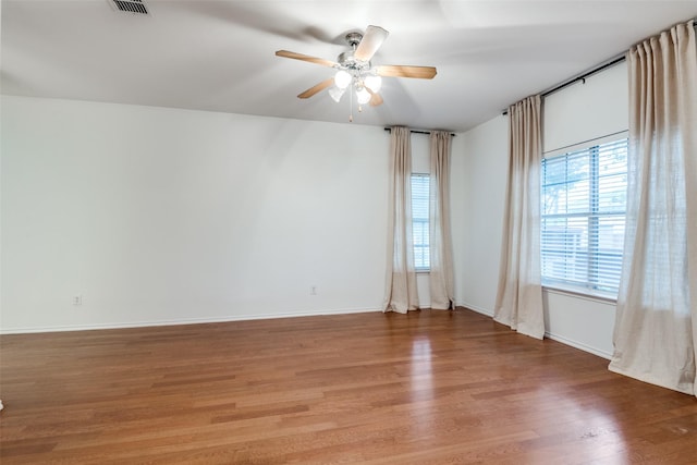 spare room featuring wood-type flooring and ceiling fan