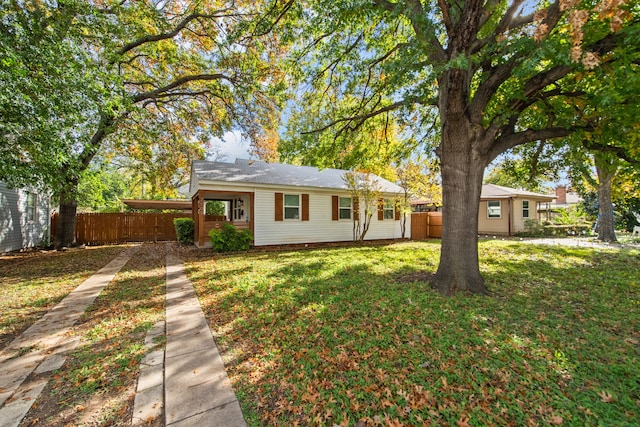 ranch-style home with a carport and a front lawn