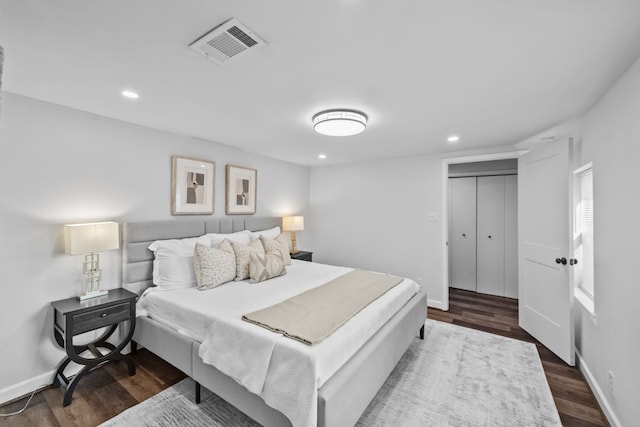 bedroom with a closet and dark hardwood / wood-style floors