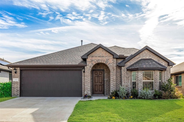 view of front of home with a garage and a front yard