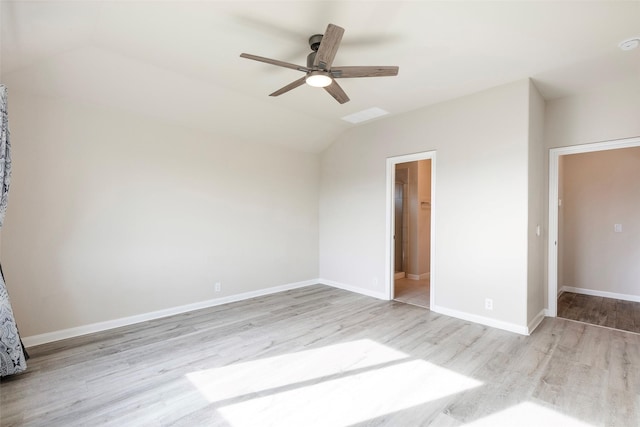 unfurnished bedroom with ceiling fan, a spacious closet, light hardwood / wood-style flooring, lofted ceiling, and a closet