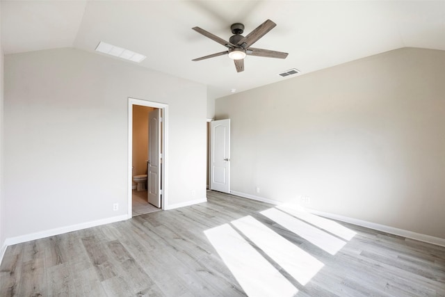 unfurnished bedroom featuring ensuite bathroom, ceiling fan, vaulted ceiling, and light hardwood / wood-style flooring