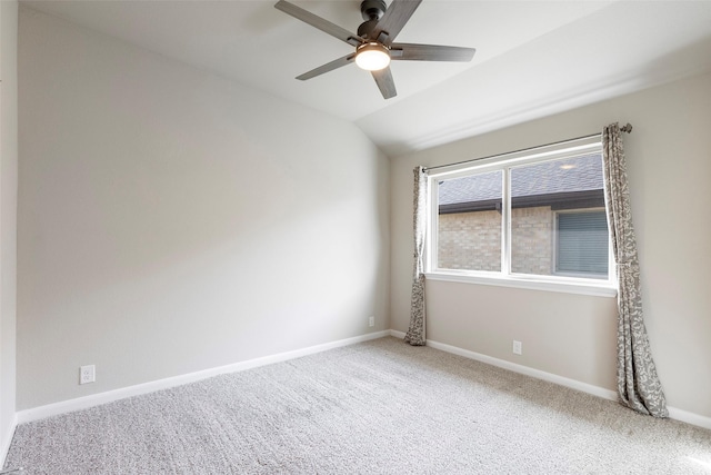 empty room featuring carpet flooring, vaulted ceiling, and ceiling fan