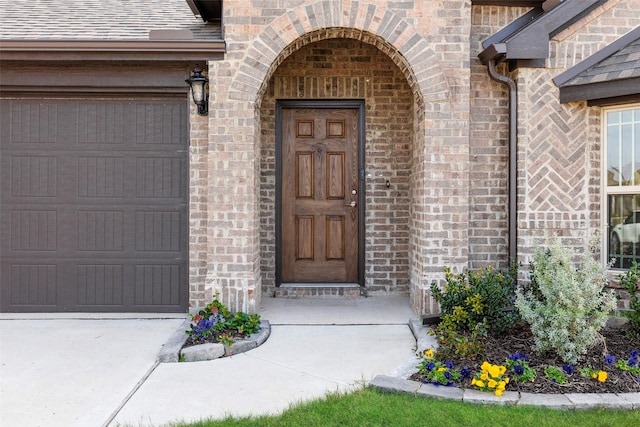 view of exterior entry with a garage