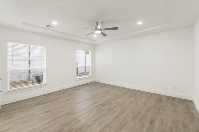 1385 Melcer St, Frisco, TX 75036 - unfurnished room with light wood-type flooring, a raised ceiling, ceiling fan, and visible vents