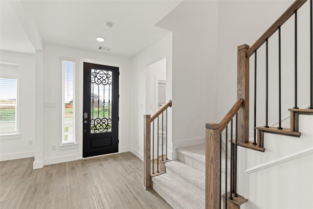1385 Melcer St, Frisco, TX 75036 - entrance foyer with baseboards, visible vents, light wood-style flooring, and stairs