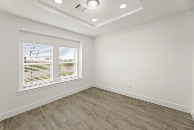 1385 Melcer St, Frisco, TX 75036 - unfurnished room with recessed lighting, baseboards, a raised ceiling, visible vents, and wood finished floors