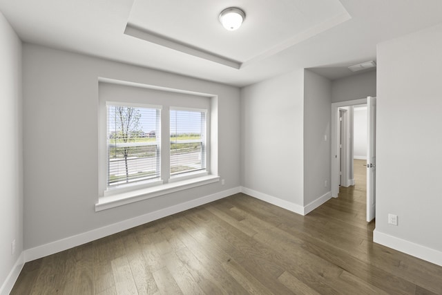 1590 Marburg Ln, Frisco, TX 75036 - spare room with baseboards, dark wood finished floors, and a raised ceiling