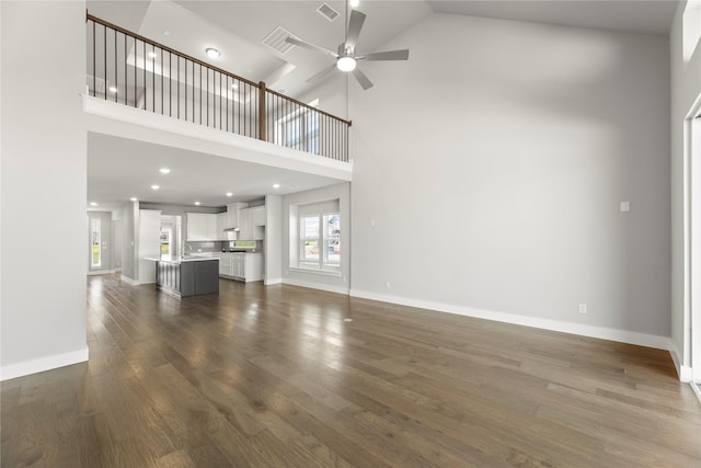1590 Marburg Ln, Frisco, TX 75036 - unfurnished living room with high vaulted ceiling, a ceiling fan, dark wood-type flooring, and baseboards
