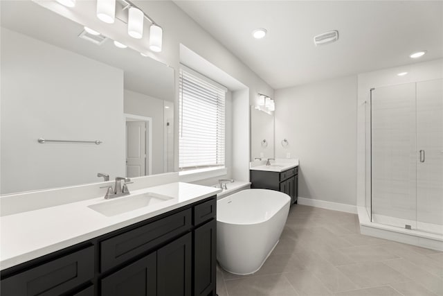 1590 Marburg Ln, Frisco, TX 75036 - bathroom with a shower stall, a freestanding bath, tile patterned flooring, two vanities, and recessed lighting