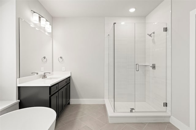 1590 Marburg Ln, Frisco, TX 75036 - full bath with a shower stall, vanity, a freestanding bath, baseboards, and recessed lighting