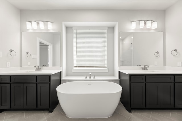 1590 Marburg Ln, Frisco, TX 75036 - full bath featuring tile patterned floors, a freestanding bath, two vanities, and a shower