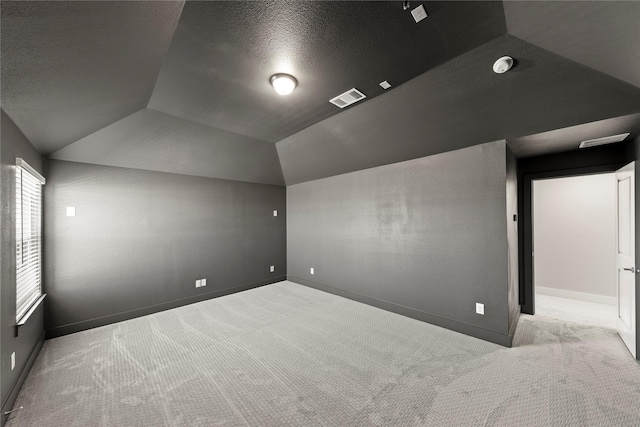1590 Marburg Ln, Frisco, TX 75036 - additional living space with carpet, vaulted ceiling, baseboards, and a textured ceiling