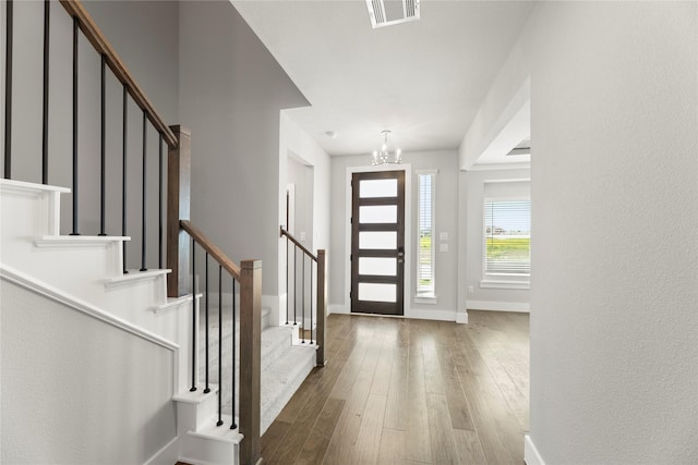 1590 Marburg Ln, Frisco, TX 75036 - entrance foyer with stairs, hardwood / wood-style flooring, a chandelier, and baseboards