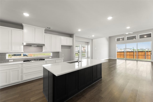 1590 Marburg Ln, Frisco, TX 75036 - kitchen with a sink, under cabinet range hood, stainless steel gas cooktop, backsplash, and light countertops