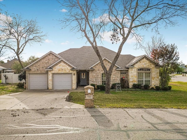 view of front of home featuring a garage and a front yard