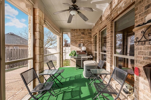 unfurnished sunroom featuring ceiling fan