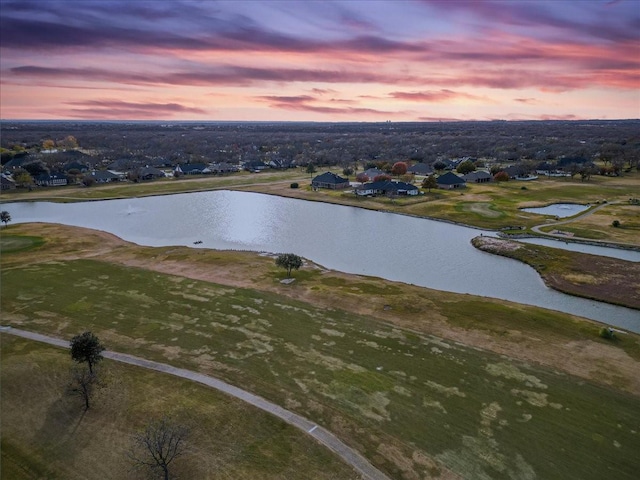 aerial view at dusk with a water view