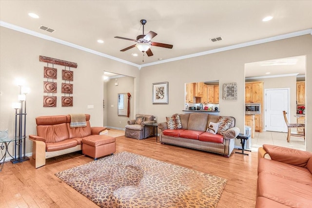 living room with ceiling fan, light hardwood / wood-style flooring, and ornamental molding