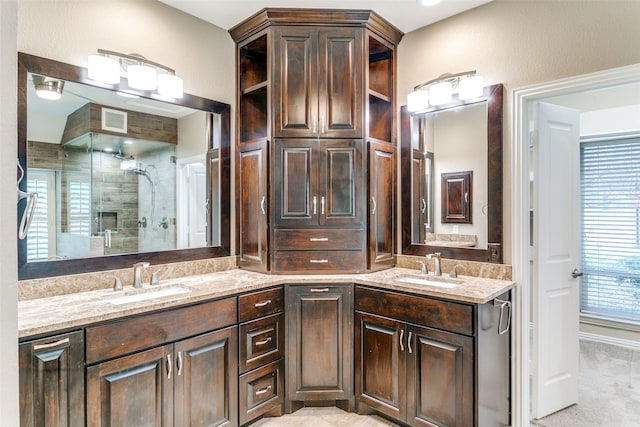 bathroom featuring vanity and a shower with shower door