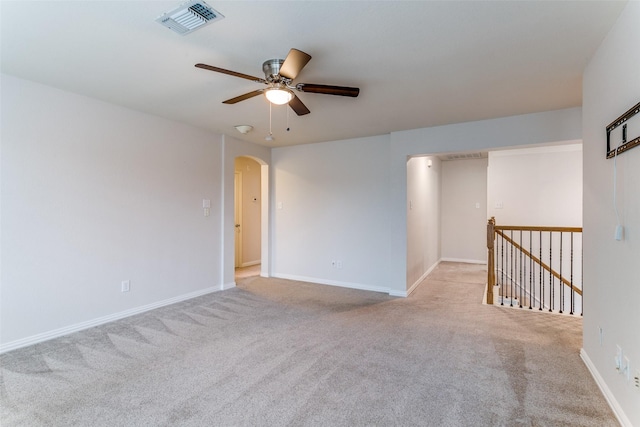 unfurnished room featuring light colored carpet and ceiling fan